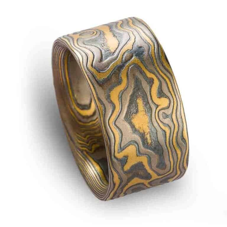 extra wide flat profile mokume gane woodgrain patterned ring, made with yellow gold, palladium and oxidized silver layers