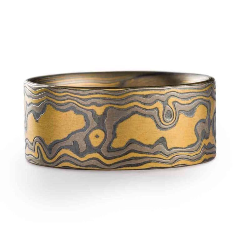 extra wide flat profile mokume gane woodgrain patterned ring, made with yellow gold, palladium and oxidized silver layers