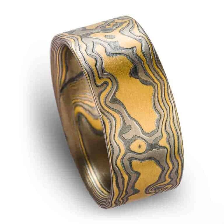 extra wide flat profile mokume gane woodgrain patterned ring, made with yellow gold, palladium and oxidized silver layers