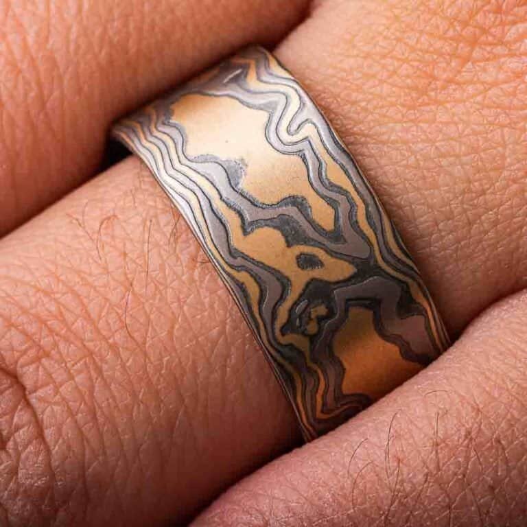 extra wide flat profile mokume gane woodgrain patterned ring, made with yellow gold, palladium and oxidized silver layers