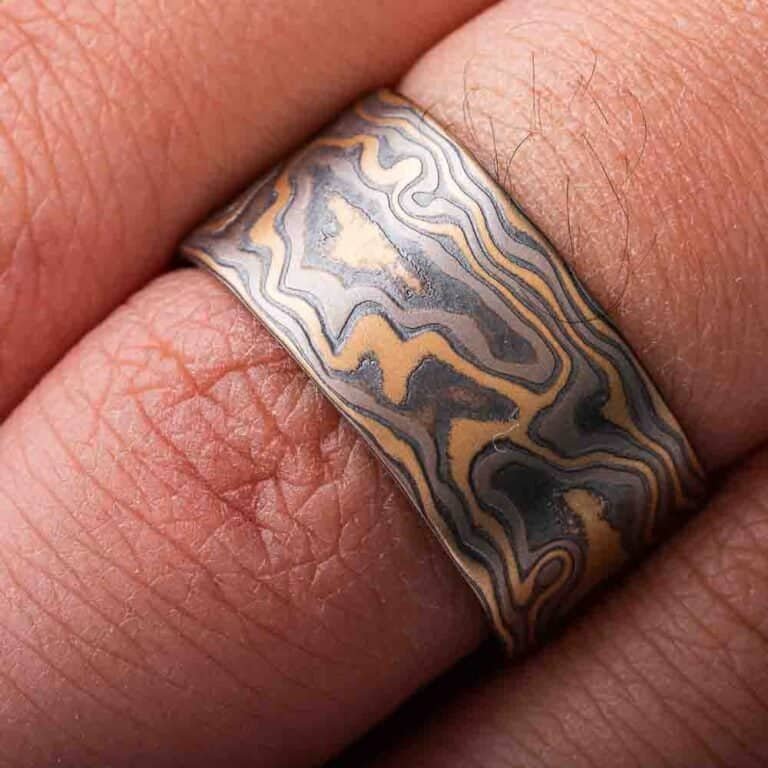 extra wide flat profile mokume gane woodgrain patterned ring, made with yellow gold, palladium and oxidized silver layers