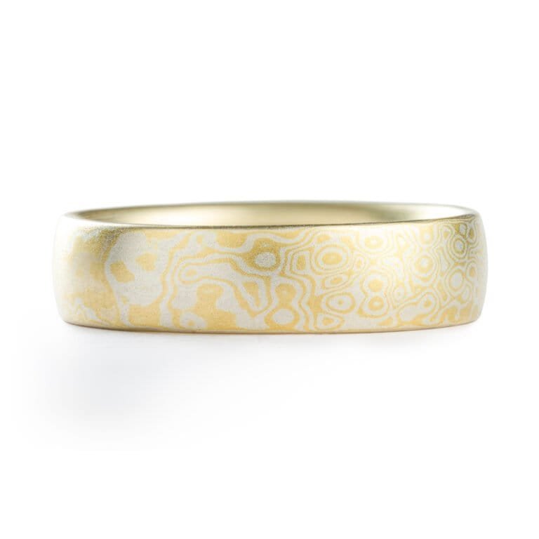 Gold and silver mokume gane patterned ring by arn krebs, pattern resembles droplets hitting the surface of water