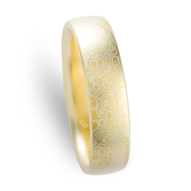 Gold and silver mokume gane patterned ring by arn krebs, pattern resembles droplets hitting the surface of water