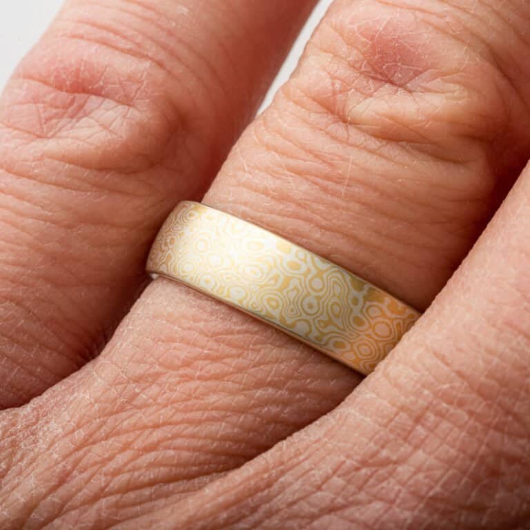 Gold and silver mokume gane patterned ring by arn krebs, pattern resembles droplets hitting the surface of water