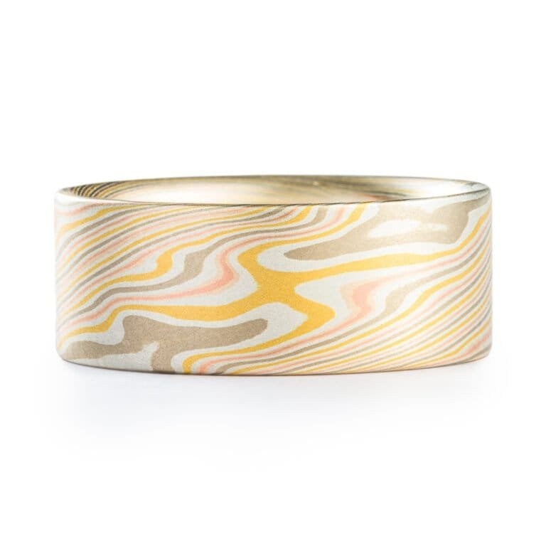 wide mokume gane twist patterned ring with a flat profile, ring is made with layers of red and yellow gold, palladium and etched silver