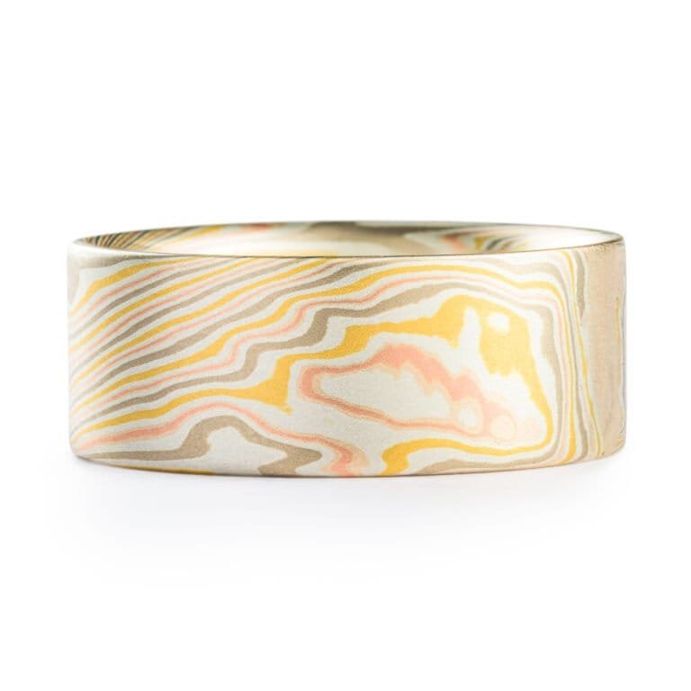 wide mokume gane twist patterned ring with a flat profile, ring is made with layers of red and yellow gold, palladium and etched silver