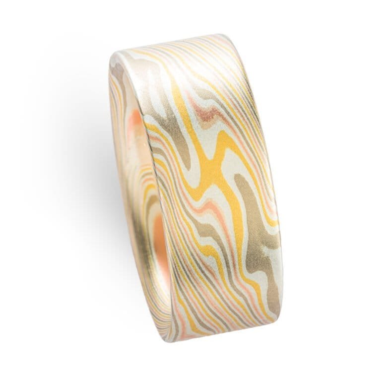 wide mokume gane twist patterned ring with a flat profile, ring is made with layers of red and yellow gold, palladium and etched silver