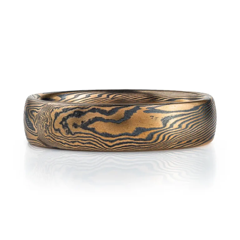 Mokume gane ring mens wedding band High contrast mokume gane mens wedding band ring. Unisex. Gold and blackened oxidized black sterling silver unique nature inspired woodgrain patterned two toned tone yellow white gold alternative metal