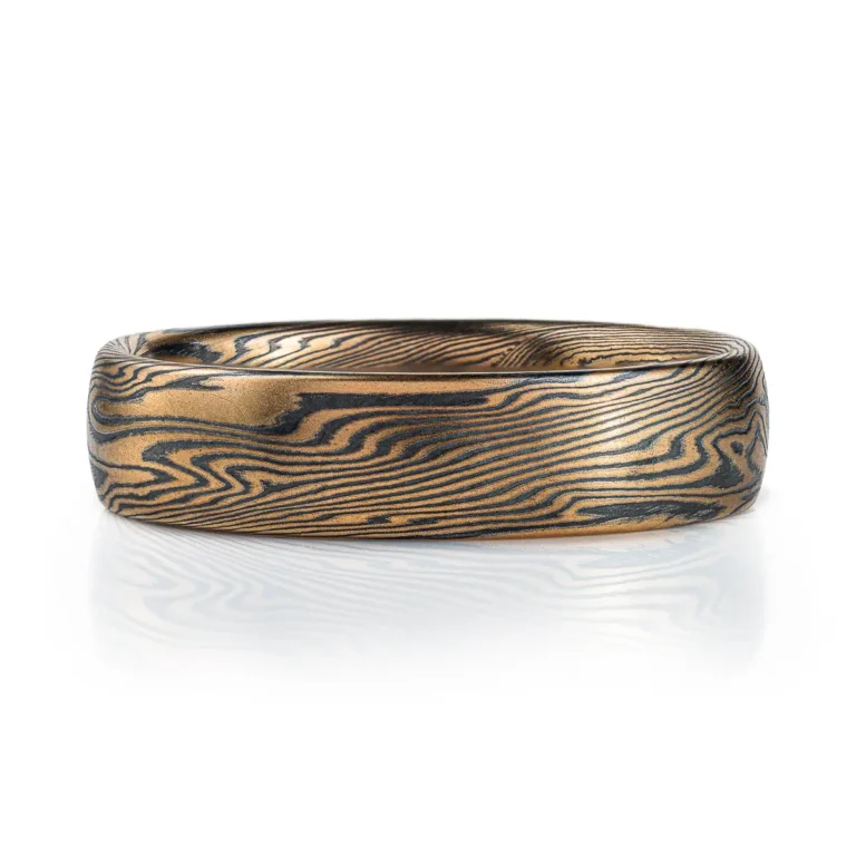 Mokume gane ring mens wedding band High contrast mokume gane mens wedding band ring. Unisex. Gold and blackened oxidized black sterling silver unique nature inspired woodgrain patterned two toned tone yellow white gold alternative metal