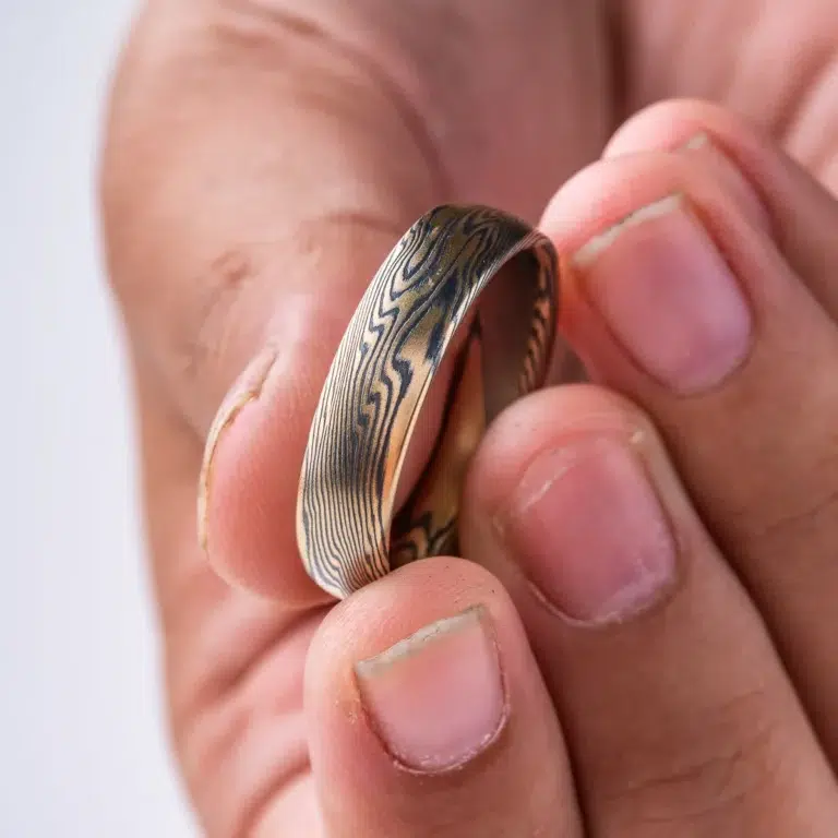 Mokume gane ring mens wedding band High contrast mokume gane mens wedding band ring. Unisex. Gold and blackened oxidized black sterling silver unique nature inspired woodgrain patterned two toned tone yellow white gold alternative metal