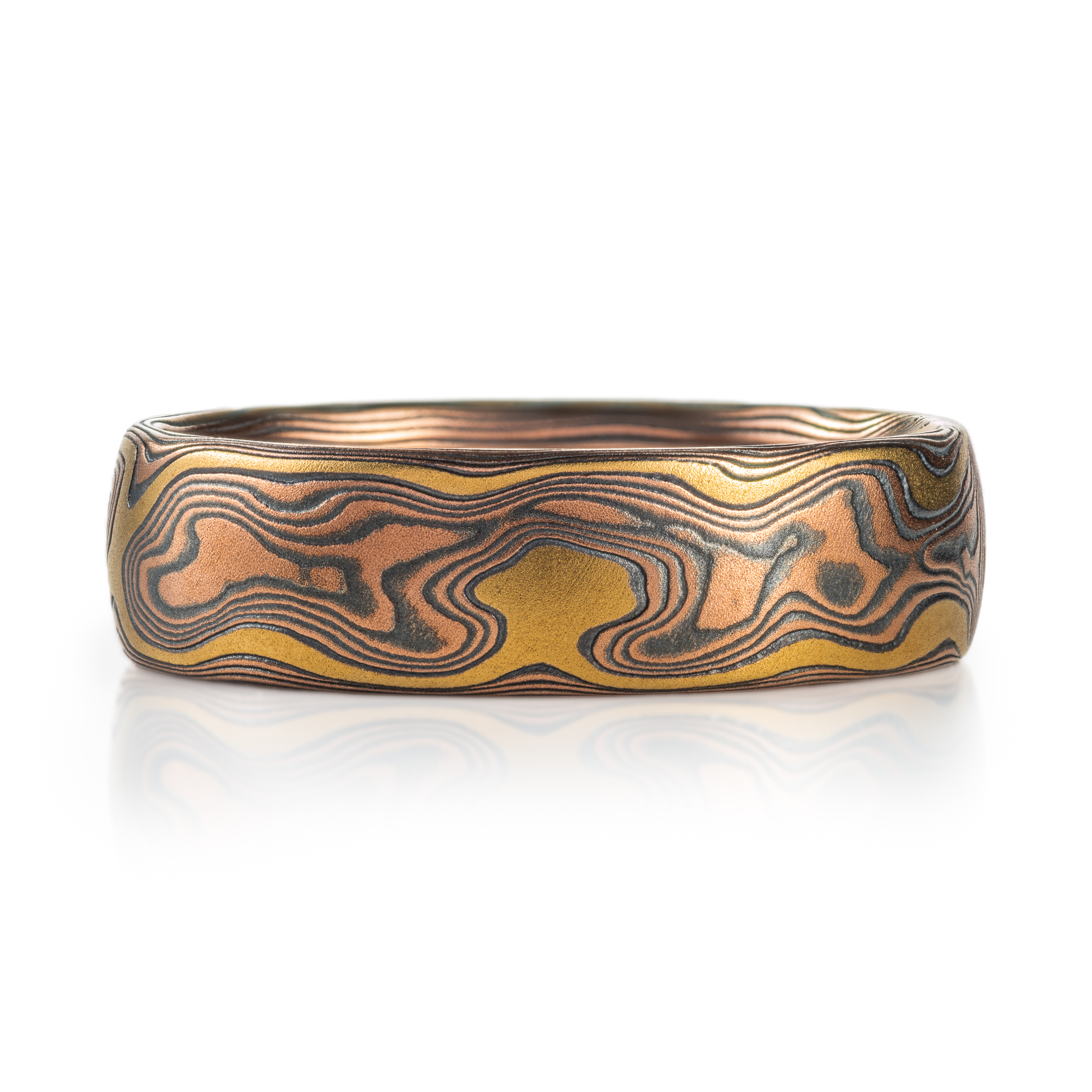 mokume gane arn krebs band featuring a yellow gold accent stratum paired with woodgrain patterning