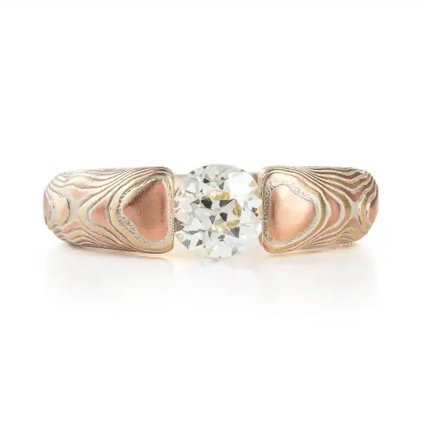 mokume gane tension set ring with diamond in guri bori pattern and gold and silver