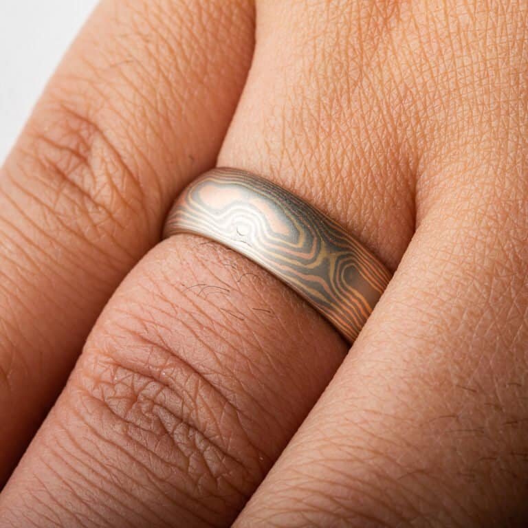 Rustic and elegant Mokume Gane band with woodgrain pattern and Cinders metal combination in low dome and satin finish.