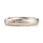 small narrow band made in twisted mokume pattern, overall silvery palette with added stripe of yellow gold as an accent
