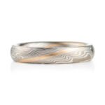 small narrow band made in twisted mokume pattern, overall silvery palette with added stripe of yellow gold as an accent