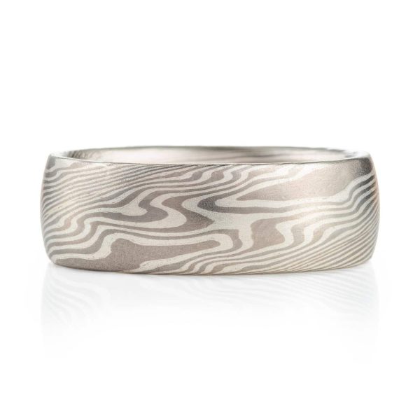 ash palette ring made with layers of palladium and silver, made in a twisted mokume gane pattern