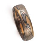 Mokume gane with a rustic earthy look, shown in a four color metal combination of red gold, yellow gold, palladium and oxidized silver