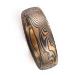 Mokume gane with a rustic earthy look, shown in a four color metal combination of red gold, yellow gold, palladium and oxidized silver