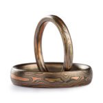 Matching ring set, mokume gane woodgrain patterned, both are very slim rings, upright ring is 2mm and laid down one is 4mm, metals in the rings are red gold silver and palladium