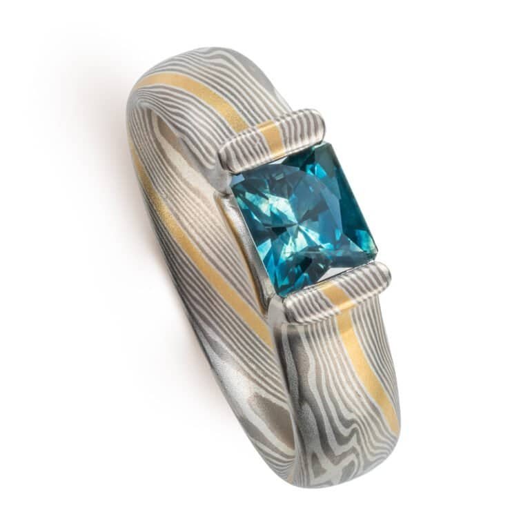 mokume ring with sapphire custom set in bloom style settting. modern heirloom