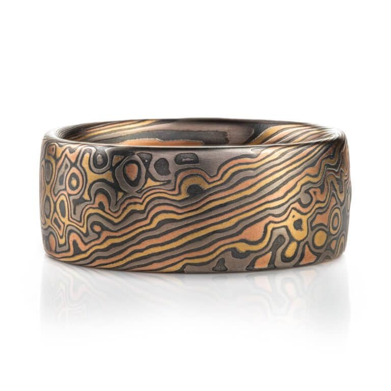 Wide mokume gane ring shown in combination pattern, Twist and Droplet for a mixture of flowing lines and a speckled affect intended to resemble drops of water rippling on a surface