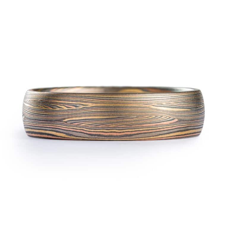 fine lines in this contemporary ring with Tri golds and silver. flowing lines. Todd reed quality. high end. fine jewelry and fine art ring with signature pattern