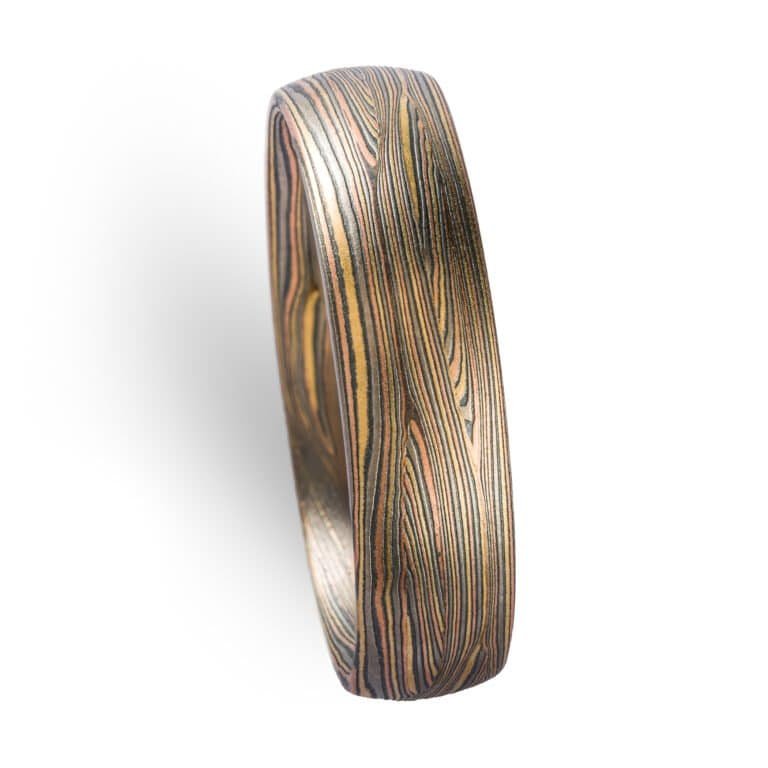 fine lines in this contemporary ring with Tri golds and silver. flowing lines. Todd reed quality. high end. fine jewelry and fine art ring with signature pattern