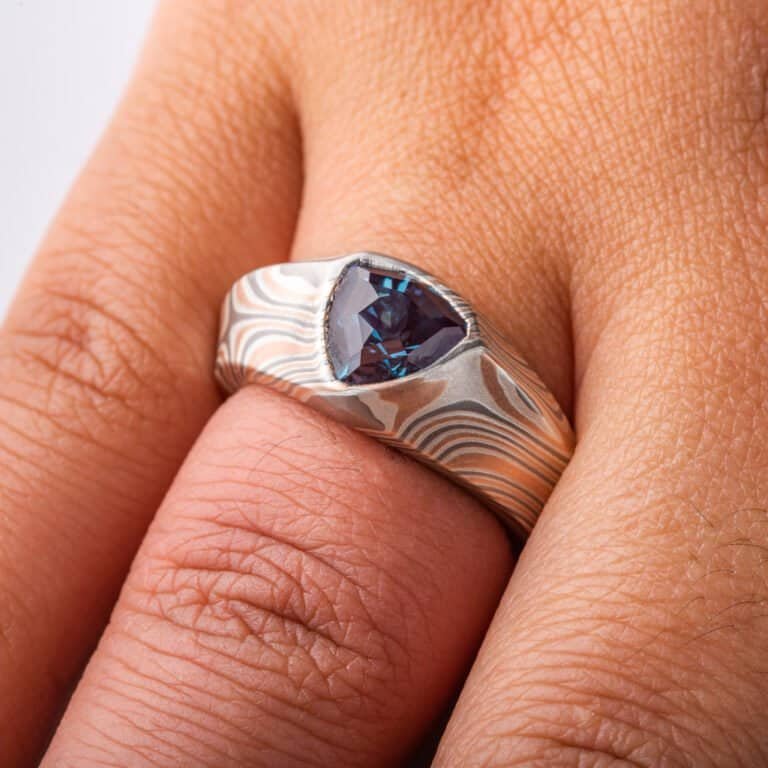 custom made mokume gane ring, wide tapered ring with a beveled edge and large triangular blue stone