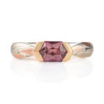 mokume gane engagement style ring featuring long hexagonal shaped dusty pink sapphire