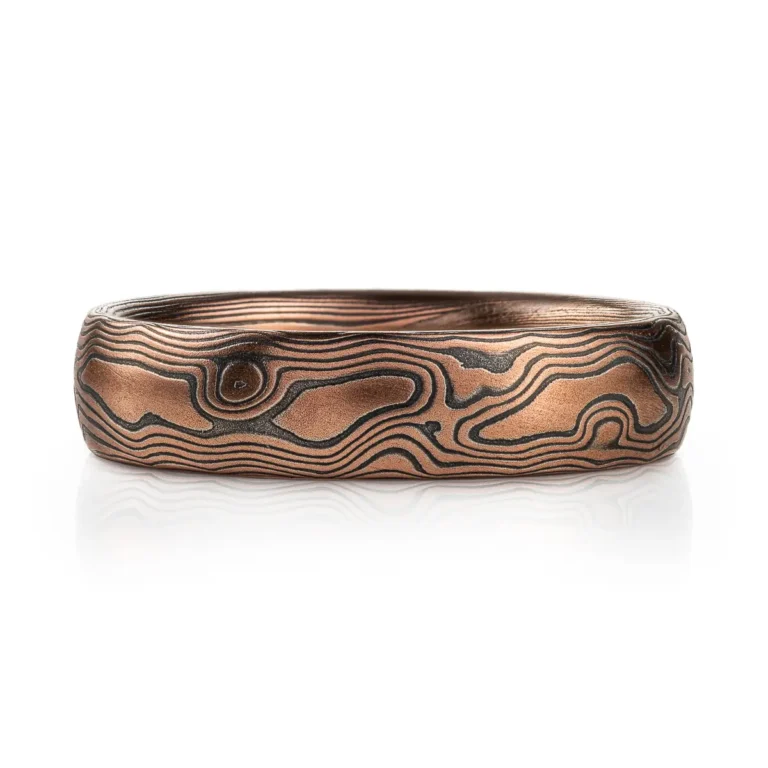 Red gold mokume gane ring with oxidized silver in a woodgrain pattern