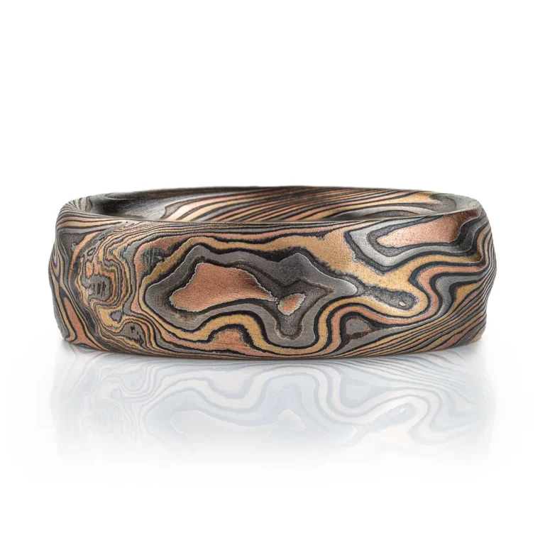 arn krebs mokume gane handmade wedding ring, in twist pattern and Firestorm palette with red gold yellow gold palladium and oxidized silver