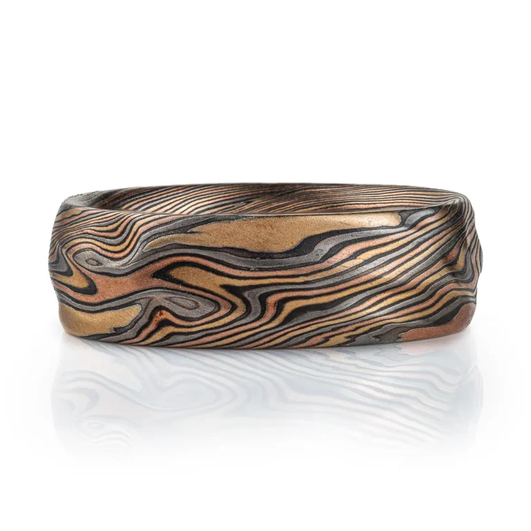 arn krebs mokume gane handmade wedding ring, in twist pattern and Firestorm palette with red gold yellow gold palladium and oxidized silver