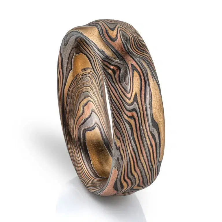 arn krebs mokume gane handmade wedding ring, in twist pattern and Firestorm palette with red gold yellow gold palladium and oxidized silver