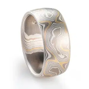 mokume gane wide mens woodgrain pattern ring in a silvery palette with an added layer of yellow gold for contrast