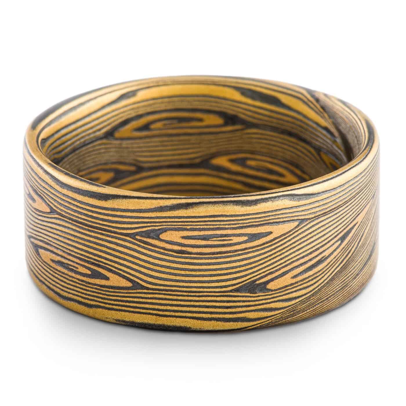 intricately patterned yellow gold and oxidized silver ring in Arn Krebs flow pattern