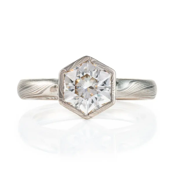 beautiful mokume gane ring with hexagon shaped moissanite in a floating mokume bezel with a light silvery palette