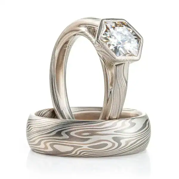 Coordinating mokume gane wedding rings in Smoke palette with moissanite stone. 