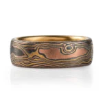 18kt yellow gold mokume gane ring in woodgrain pattern with domed profile, ring is made with golds and oxidized silver