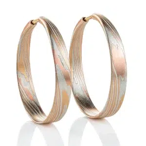 Flat mokume hoop earrings featuring red and yellow gold and etched silver.