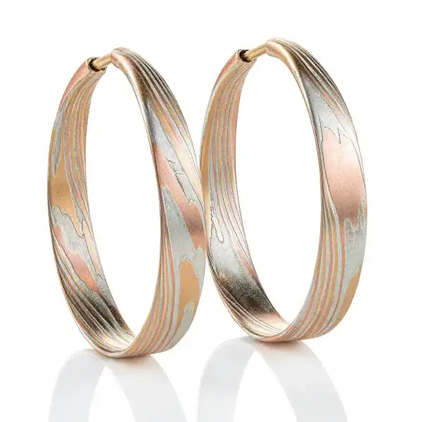 flat profile mokume gane patterned hoop earrings made with red and yellow gold and silver