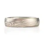 mokume gane low dome band in twisted pattern using white gold, silver and palladium