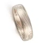 mokume gane low dome band in twisted pattern using white gold, silver and palladium