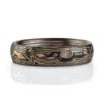 mokume gane woodgrain patterned ring with etched and textured finish, made with yellow gold, palladium and oxidized silver