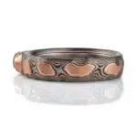 dimensional mokume gane patterned ring made to resemble rocks, with a dark diamond crystal set into it