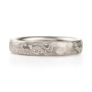 light silvery colored mokume gane ring made in woodgrain pattern with surface carving for added texture