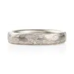 light silvery colored mokume gane ring made in woodgrain pattern with surface carving for added texture