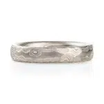 light silvery colored mokume gane ring made in woodgrain pattern with surface carving for added texture