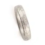 light silvery colored mokume gane ring made in woodgrain pattern with surface carving for added texture