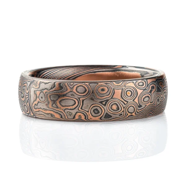 Dark palette mokume gane patterned ring, made in combination pattern with twisted and droplet style elements. Shown here in a combination of red gold, palladium and oxidized silver