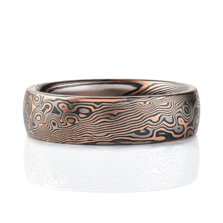 Dark palette mokume gane patterned ring, made in combination pattern with twisted and droplet style elements. Shown here in a combination of red gold, palladium and oxidized silver